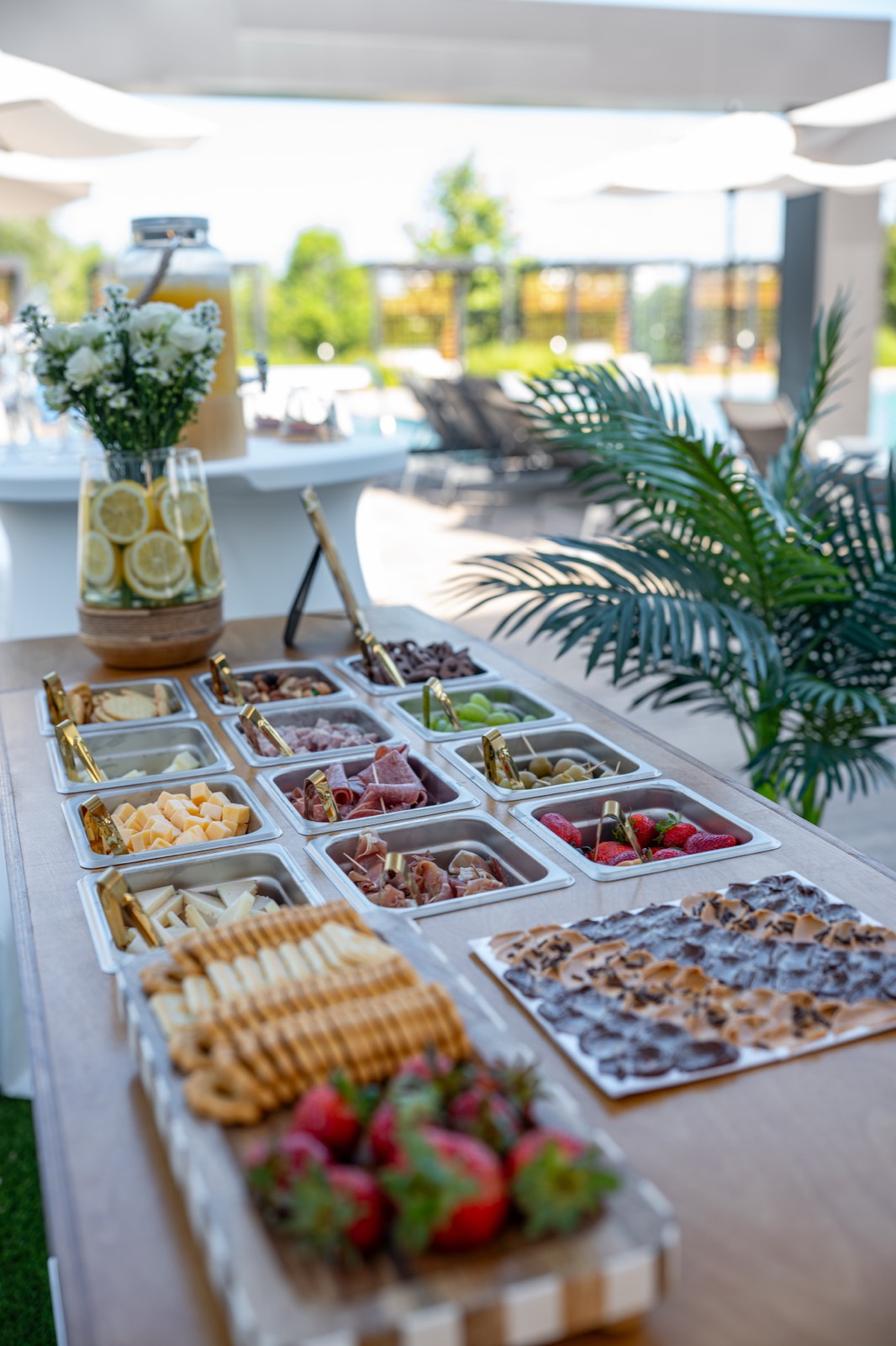 Buffet de charcutería completo con frutas, carnes, quesos y postres